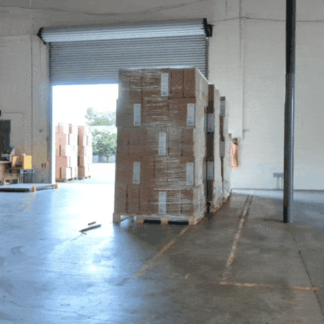 A gif of forklifts moving several pallets.