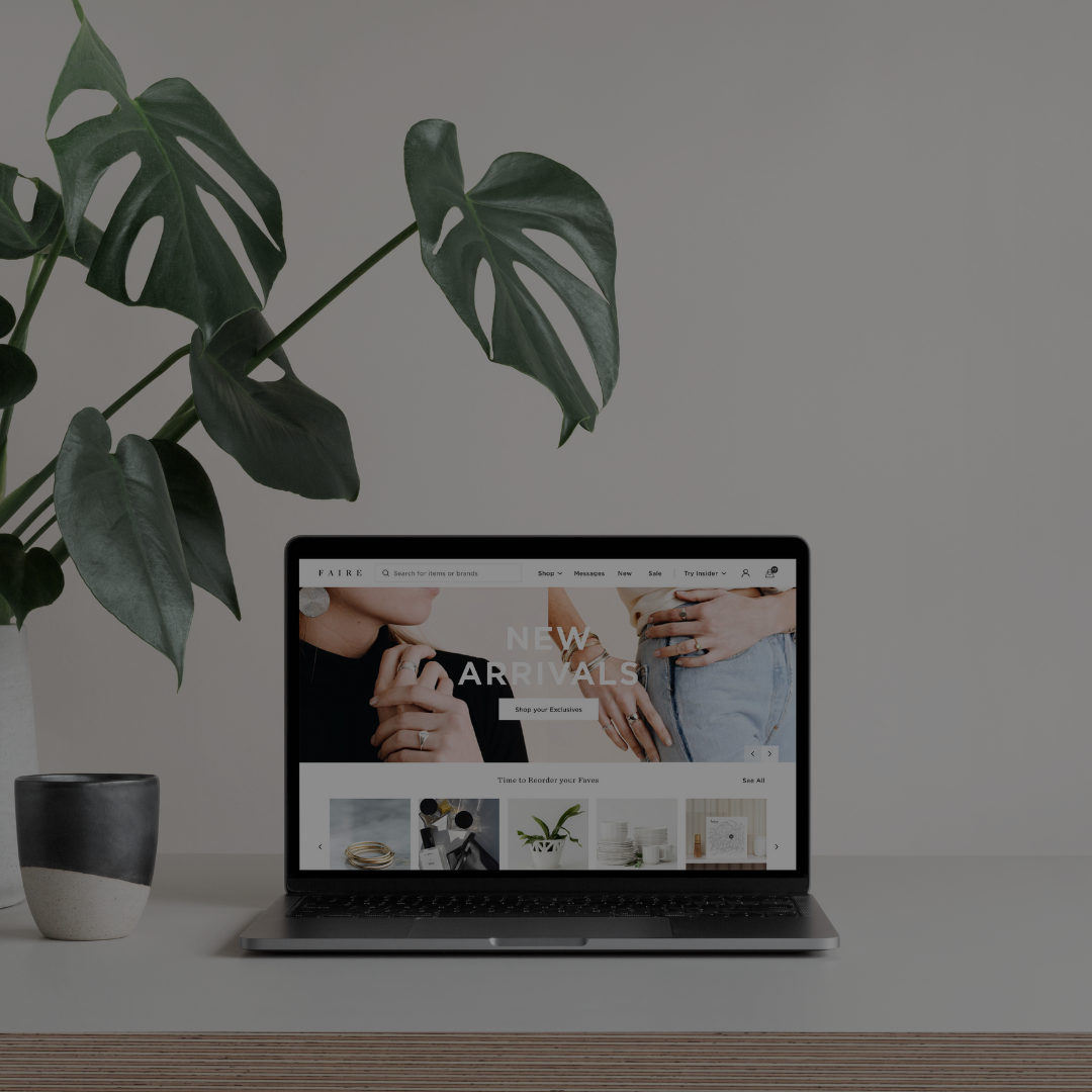 Picture of a laptop on a table showing Faire's site to showcase the upcoming market.