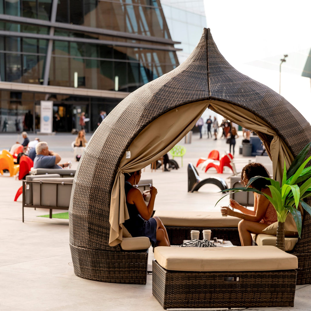 A picture of the outdoor courtyard of the Las Vegas Market Center in Vegas showing people enjoying the outdoors taking a break.